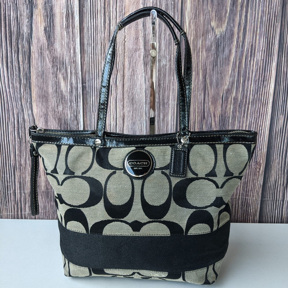 Coach signature canvas tote bag with black patent leather trim and straps.